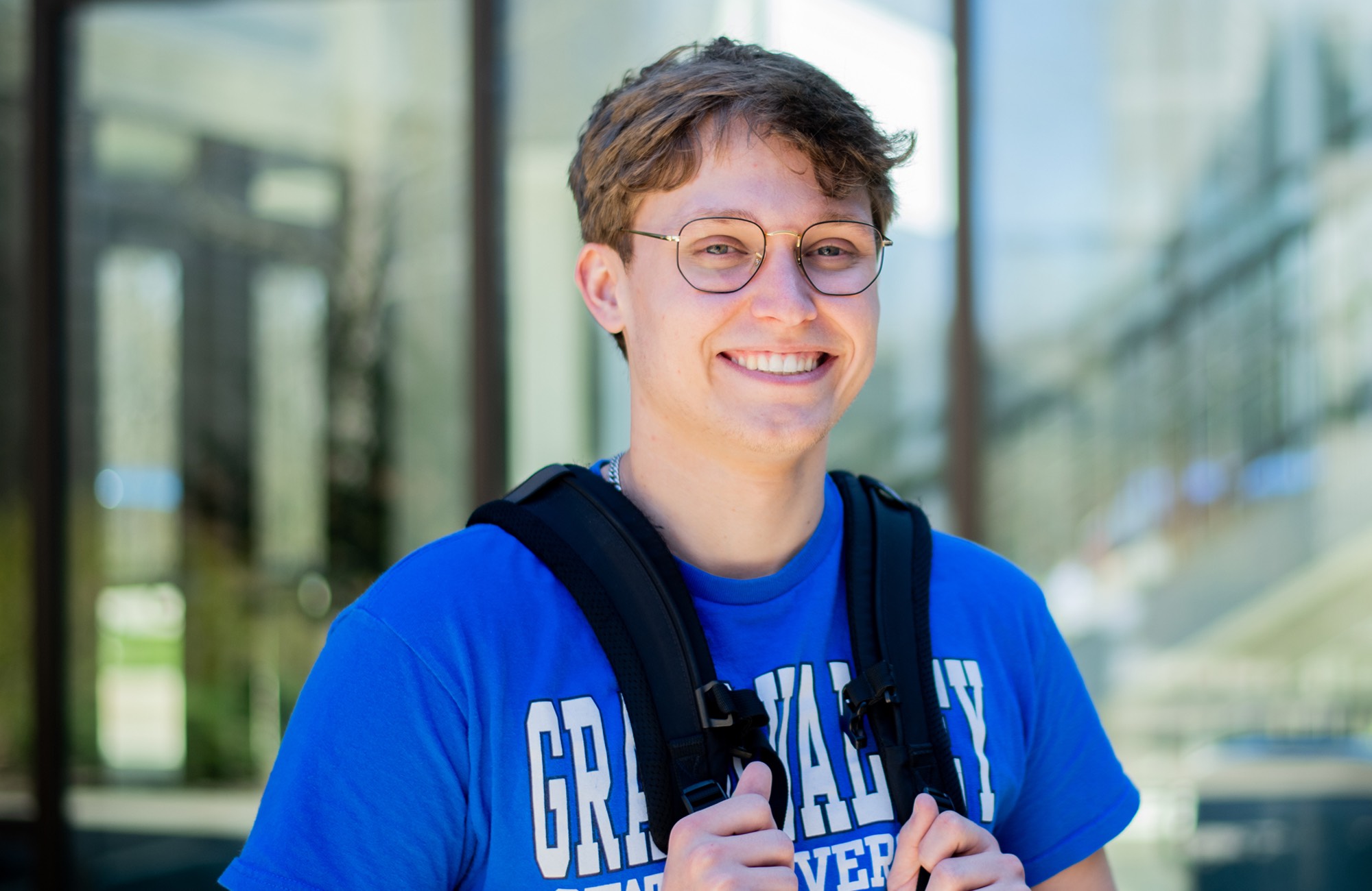 Male student smiling at camera